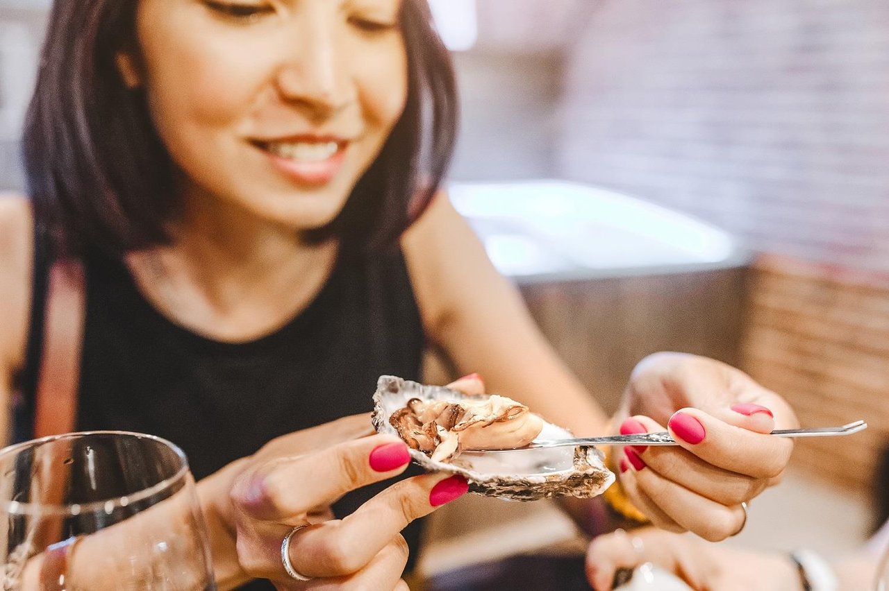 Woman eating oysters