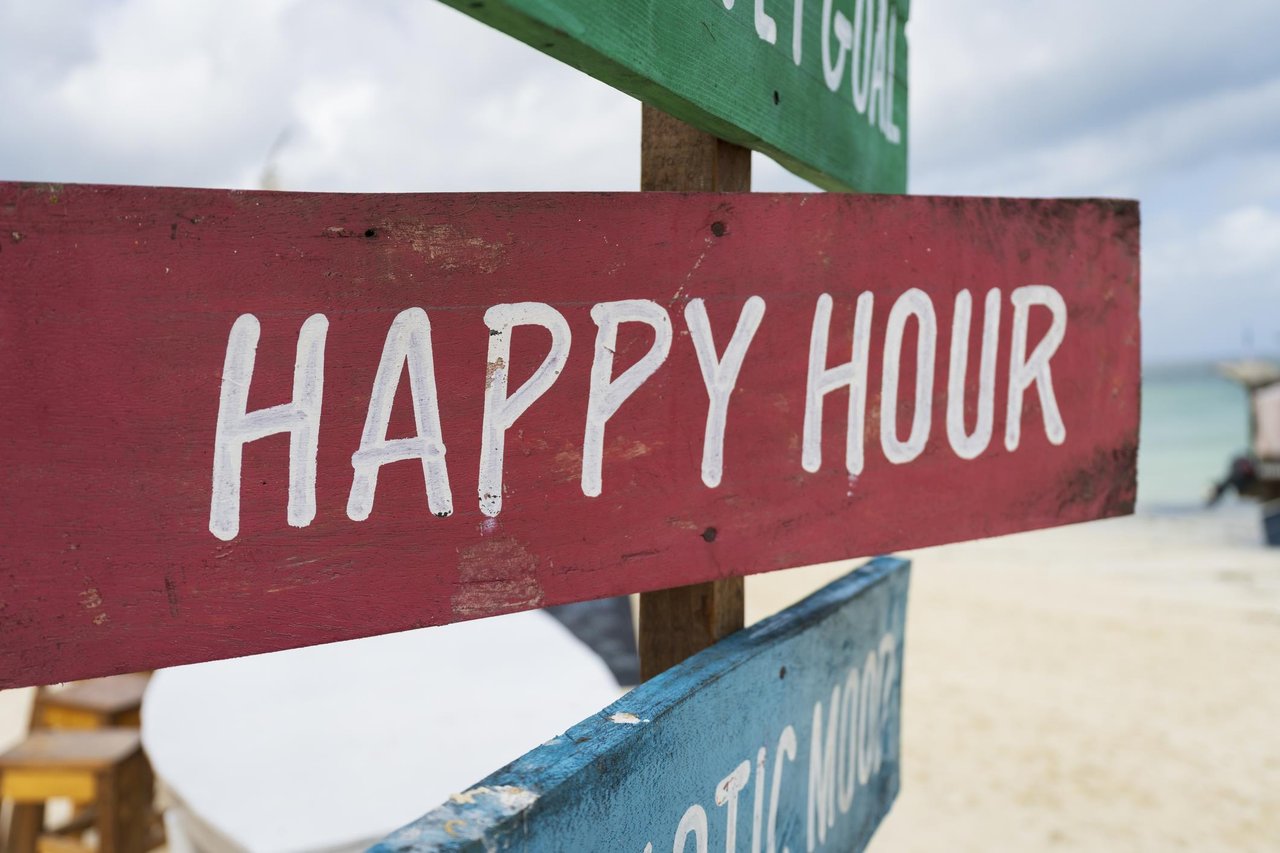 Happy hour sign on beach